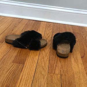 Urban Outfitters crosses faux fur slides